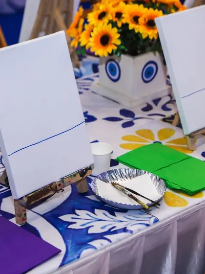 A close-up of the canvas painting setup, with blank canvases on mini easels ready for the artists to begin.