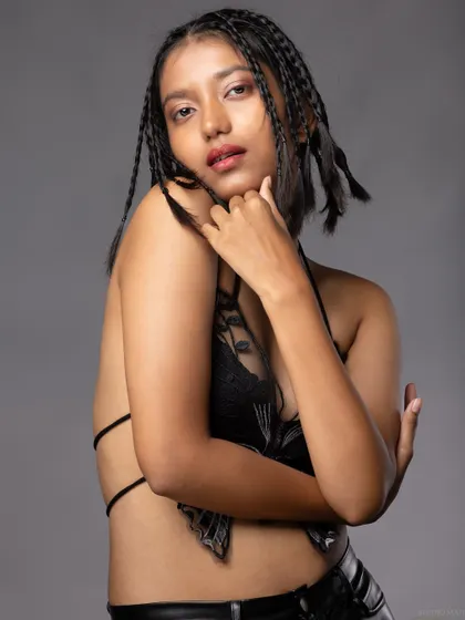 A three-quarter shot of the model in the butterfly top, with a confident pose.