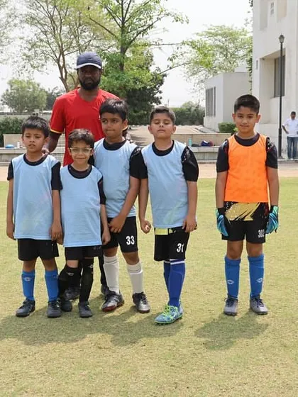 A young team poses with their coach during the DFA League.