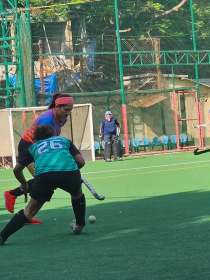 An action shot from the women's semi-final, where our player skillfully maneuvers the ball around a defender from the Savio Hockey Club.