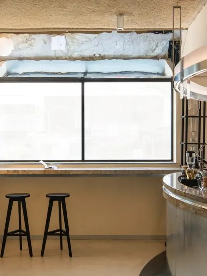 A barista at work at the manual brew station. The design puts this craft at the forefront of the customer experience.
