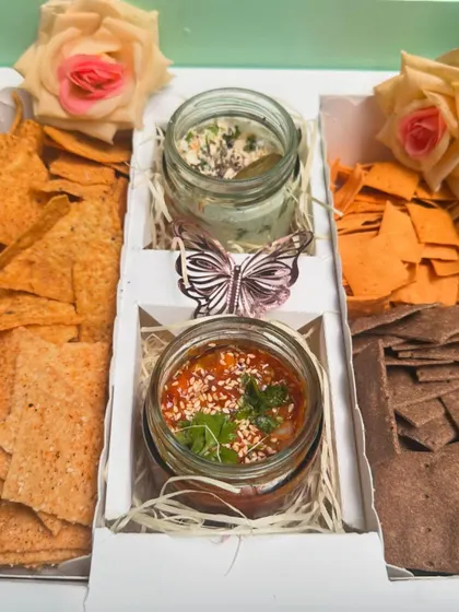 The perfect gift for snack lovers: my Cracker Box. It includes a variety of artisanal crackers like peri-peri, amaranth, and ragi, served with Mexican salsa and a spinach cream cheese dip.