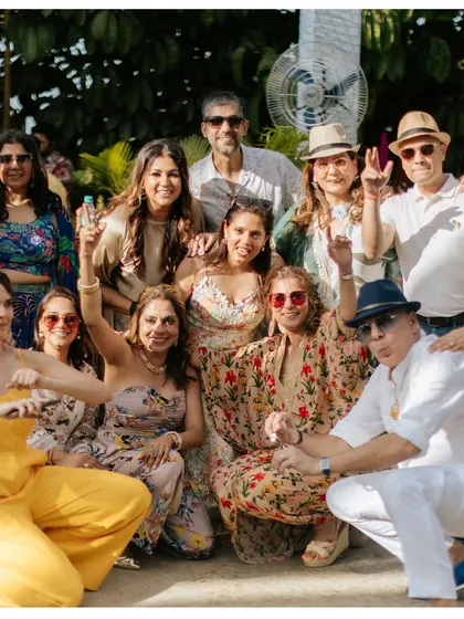 A happy group of guests posing for a photo at a sunny pool party. We create a fun and relaxed atmosphere where everyone can let loose and enjoy the celebration.