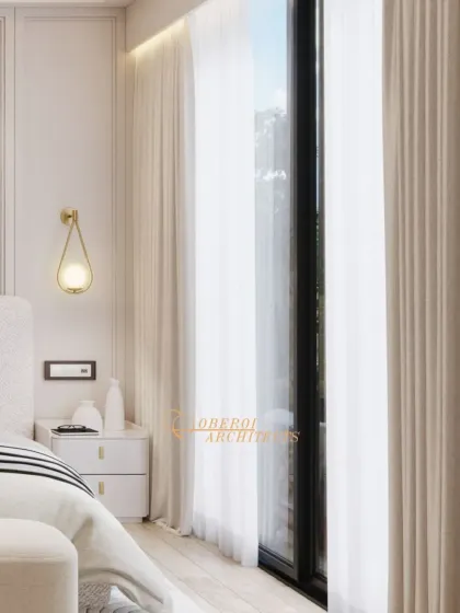 A detail shot showing the delicate wall sconce and the soft, sheer curtains that allow diffused natural light to fill the room.