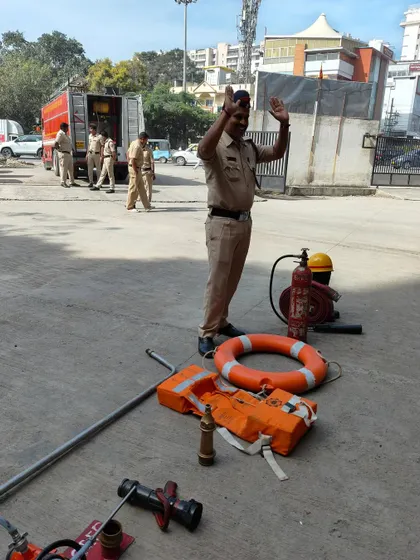 A firefighter demonstrates the equipment used for safety and rescue. These real-life demonstrations make learning impactful and memorable for the children.