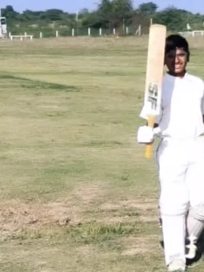 A batsman walks off the field, helmet in hand, after a good innings during the Chitradurga tour.