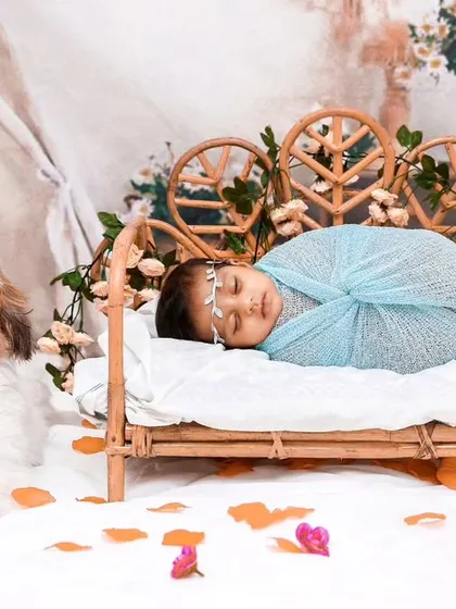 A duplicate of the charming bohemian scene with the baby in the bed and the dog watching over.
