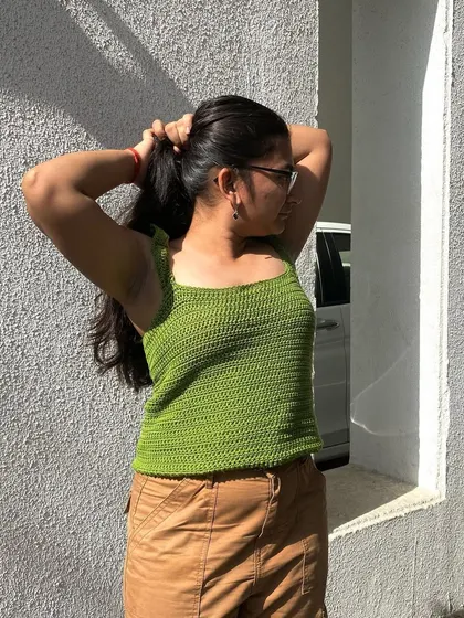 This handmade ruffle strap tank top is a great everyday piece. It's shown here in a bright green, but we can make it in any color you choose.