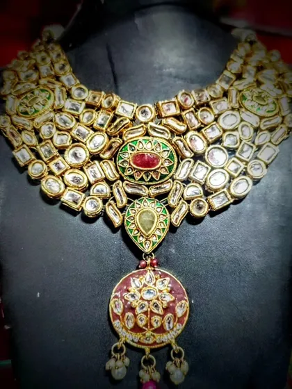 This stunning Polki wedding necklace is the epitome of royal elegance. Crafted by artisans from Bikaner, it features intricate details and uncut stones that give it an authentic, heirloom quality, perfect for your most special occasions.