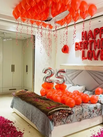 Another angle of the romantic red-themed bedroom setup, showing the pathway of rose petals leading to the bed.