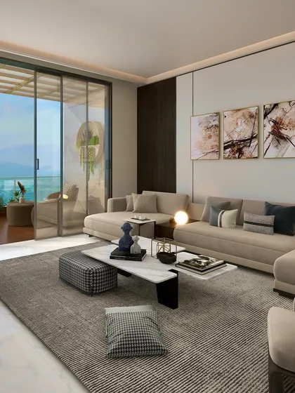 This living room in a Chattarpur farmhouse was designed to embrace the view. A large, comfortable sectional sofa is oriented towards the expansive windows, creating a space that feels both luxurious and connected to the surrounding landscape.