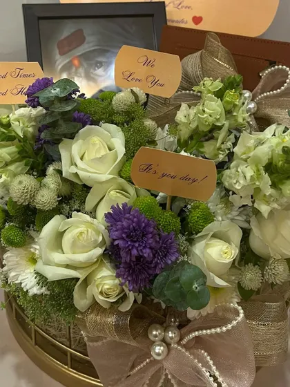 A close-up on the fresh flowers in the birthday hamper. I used a mix of white roses, chrysanthemums, and textured greens to create a garden-like feel.