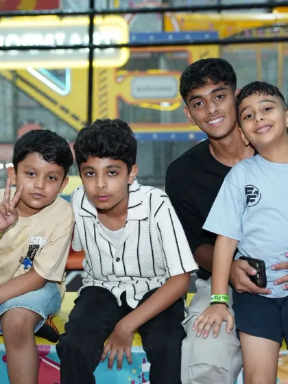 A group of older boys and friends hanging out and having a good time at the play zone.