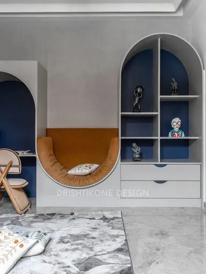 A wider view of the activity room, showcasing the built-in shelving within the arch. This area provides space for books and decor, while the plush, curved seating offers a comfortable spot to unwind.