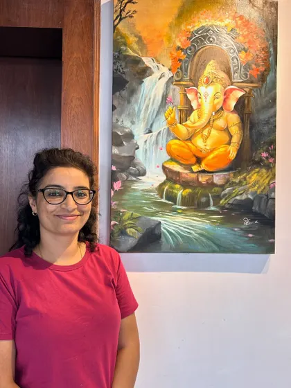 Artist with her "Mystical Ganeshji" oil painting. Ganesha is revered as the remover of obstacles, and a painting like this is perfect for inviting new beginnings and positive vibrations into any space.