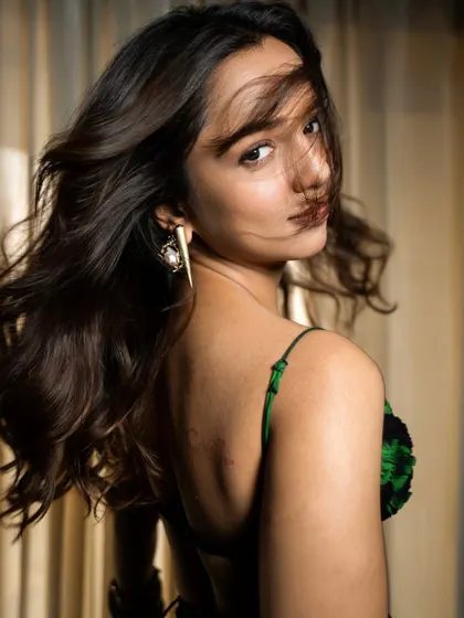 A dynamic shot showing movement in the hair and the interesting back detail of the top. Capturing energy and personality is key in a promotional photoshoot.