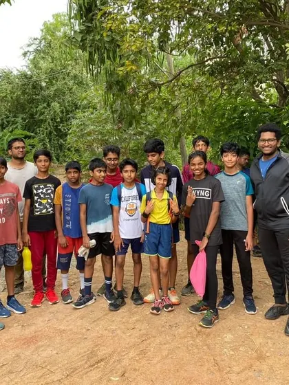 Our junior badminton group during an outdoor fitness session at Saul Kere. We believe in holistic development, incorporating cross-training to improve overall athleticism.