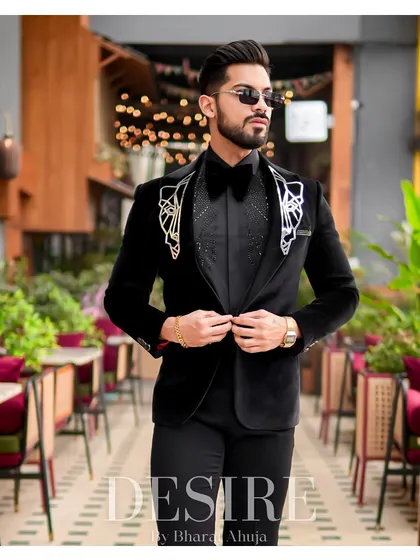 This image showcases the impeccable tailoring and luxurious feel of the black velvet tuxedo, a true statement of style and sophistication.