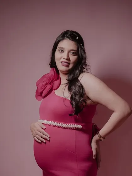 Our client looking stunning in a form-fitting magenta gown. The one-shoulder design with a large floral detail is a glamorous and modern choice.