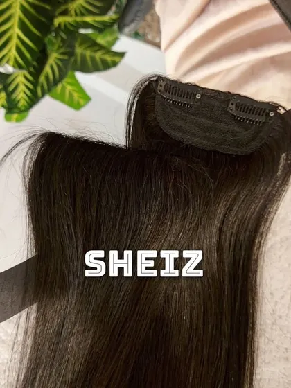 A close-up of a seamless side patch clip-in. These smaller pieces are perfect for adding volume to the sides of your hair.