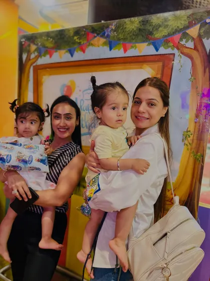 Two mothers and their toddlers pose for a picture, a snapshot of the community we build at Let's Talk Club.