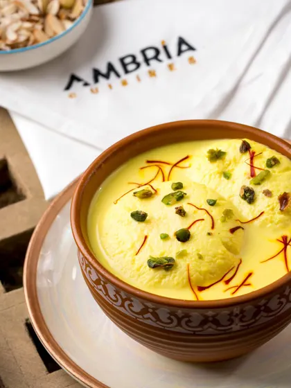 The timeless elegance of Kesari Rasmalai. Soft cheese patties are soaked in a creamy, saffron-infused milk, creating a royal dessert that melts in your mouth.