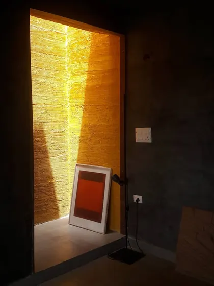 A moment captured in my studio, where a sliver of intense, yellow light from a skylight cuts through the dark interior. This image embodies my fascination with light as a primary architectural material. The way it interacts with texture and color can transform a simple space into a profound experience.
