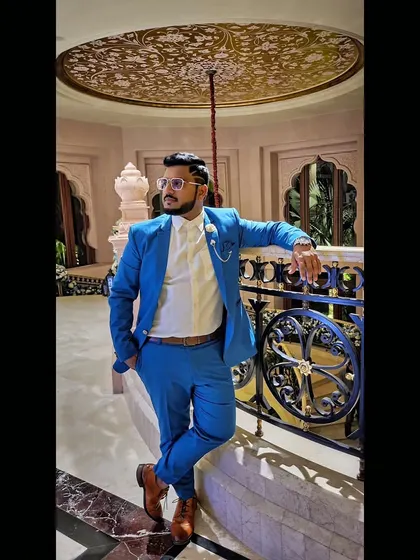 A stylish pose in a sharp blue suit. Clarity is power.