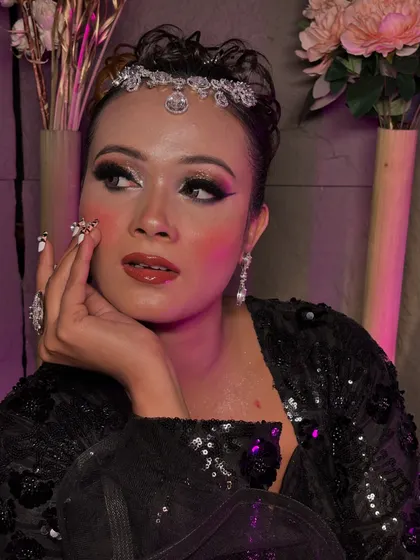 A dramatic party look with a black sequin outfit. The makeup features a sharp winged liner and a bold red lip.