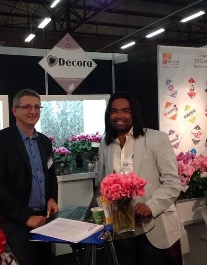 Meeting with suppliers at the Decora booth during a flower expo in Holland. Sourcing the best plant varieties is key to the success of our projects.