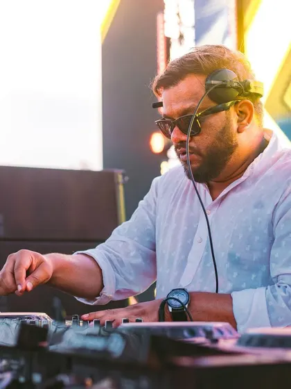 A focused shot of me at the decks during a massive Holi festival.