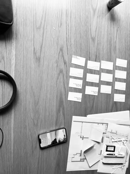 Our design process can be unconventional. Here, we are using the back of our business cards to quickly prototype and visualize a flooring pattern on a tabletop.