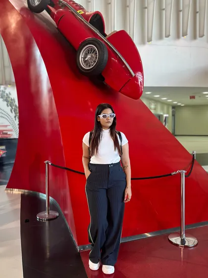 A classic red Ferrari race car. My black and white outfit is a nod to the classic colors of motorsport.