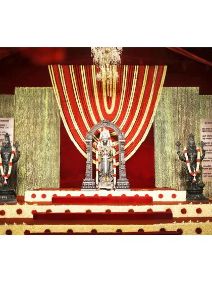 Here, you can see how we integrate sacred figures, like Lord Venkateshwara flanked by Jaya and Vijaya, into the decor. This setup creates a truly divine space where cultural symbolism meets modern elegance for a blessed celebration.