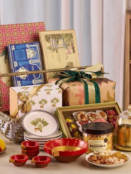 I specialize in creating grand, festive hampers that are packed with a variety of items. This example shows a large basket filled with decorative plates, gourmet dry fruits, traditional sweets, and diyas, showcasing my ability to handle large-scale, themed gifting.