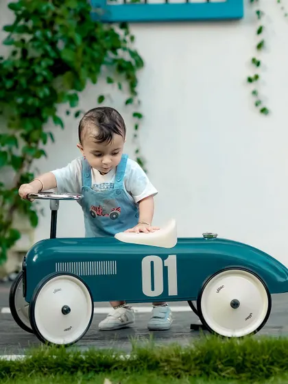 This little guy is learning to drive his cool vintage car. Our outdoor space is perfect for these kinds of action shots.