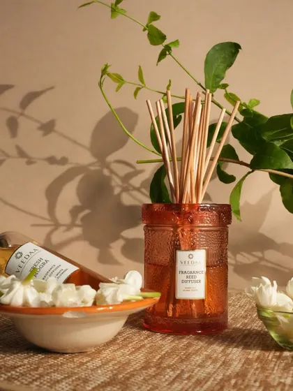Our Fresh Mogra reed diffuser, with its refill bottle and fresh jasmine flowers. This fragrance is a timeless classic, bringing the scent of a blooming Indian garden into your home.