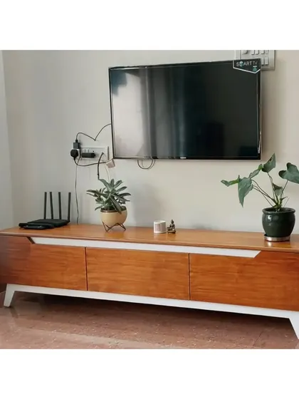 A different angle of the mid-century modern TV console, showing how it sits elegantly in the living space, complemented by indoor plants.