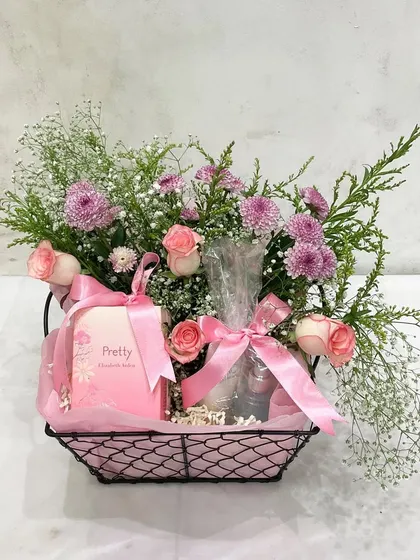The simple yet perfect way to celebrate any occasion. This pink-themed hamper with fresh flowers and a 'Pretty' chocolate bar is a great example of our everyday gifting options.