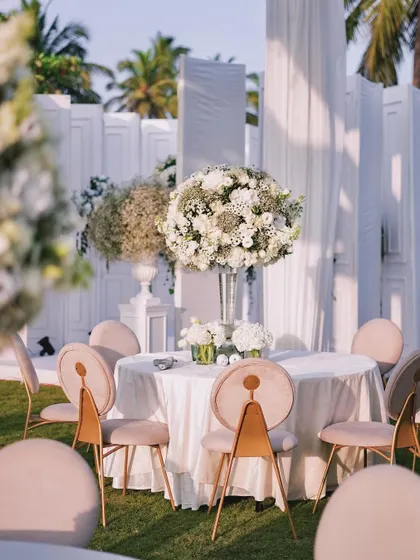 Another angle of the elegant outdoor seating, showing how the tall floral centerpieces create a sense of grandeur without obstructing the view. The design is both beautiful and practical.