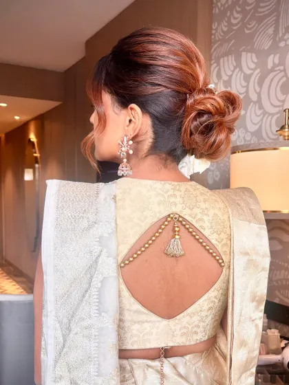 From another angle, you can see the volume and soft texture of this elegant updo. Learning to create height at the crown while keeping the bun soft is a key takeaway from my masterclass.