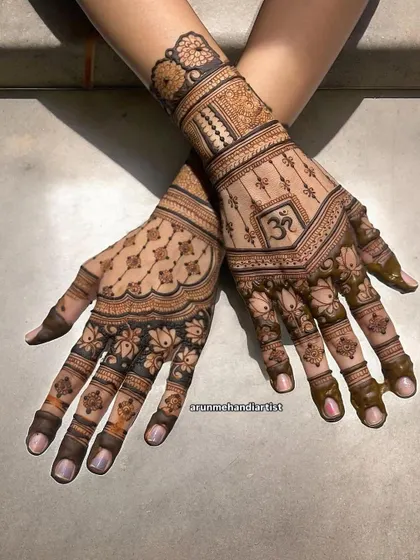 A spiritual and elegant design featuring the 'Om' symbol. This henna combines sacred elements with beautiful lotus and jaali patterns, perfect for a bride seeking a meaningful design.