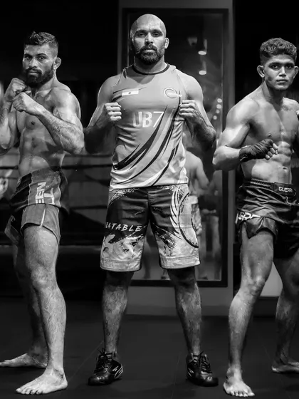 A portrait of our champions. Me standing with two of our top fighters, representing the strength and dedication of our team.