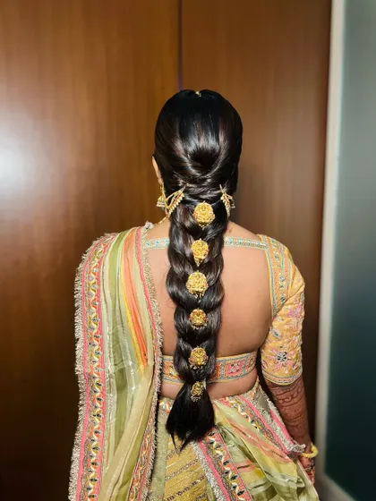 A detailed shot of the stunning traditional braid with gold accessories we did for Pari's sangeet. It's a work of art in itself.