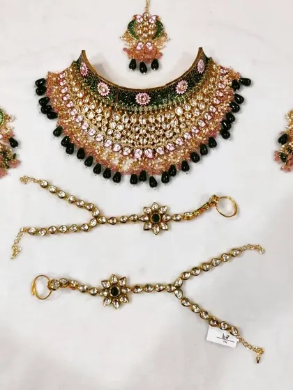 A unique bridal set featuring a mix of pink, green, and black beads. This shows my ability to customize pieces with unconventional color combinations to match a specific outfit.