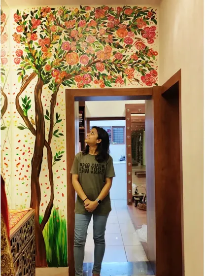 Me looking up at the finished mural in the boutique's entryway. The art transforms the passage into a beautiful experience.