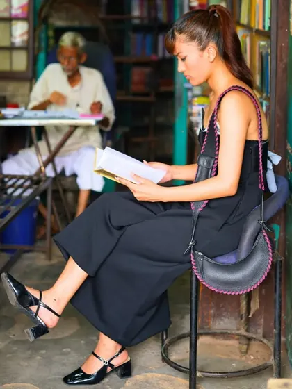 Unveiling perfection in every stitch with the Selena Whipstitch bag. This image captures a quiet moment, showing how a beautifully crafted bag can be a companion for reading and reflection.