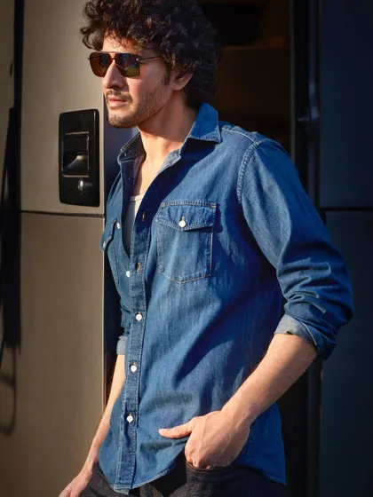 The full look from the golden light series with Mahesh Babu. The casual denim styling against the warm, setting sun creates an image that feels both rugged and effortlessly cool.