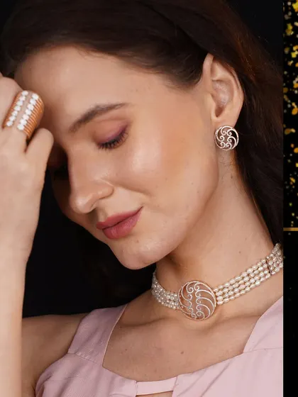 A model adorned in a unique pearl choker with a diamond and rose gold centerpiece, paired with matching earrings and ring. This set is a testament to modern elegance.