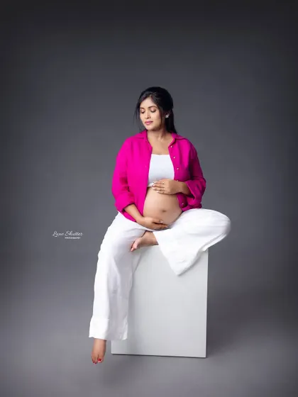 A relaxed, seated pose that feels contemporary and cool. This shows that maternity photos can be fashionable and reflect your personal style.